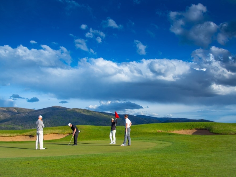 Golfers putting on a green